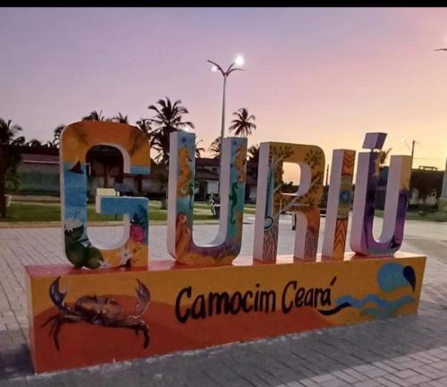 a sign for the canadian center in front of a building at Casa vila costeira Guriú in Guriú