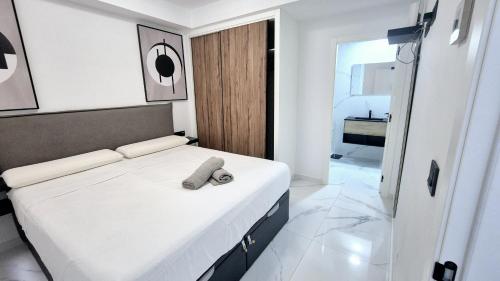 a bedroom with a bed with a remote control on it at Apartamento Lujoso Centro Torrevieja in Torrevieja