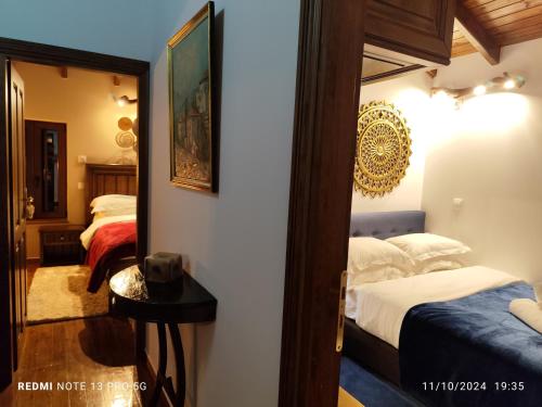 a bedroom with two beds and a mirror at Litheon House in Synikia Mesi Trikalon