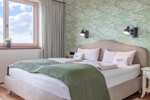 a bedroom with a bed with a green wall at Bio- und Vitalbauernhof Bacherhof in Millstatt