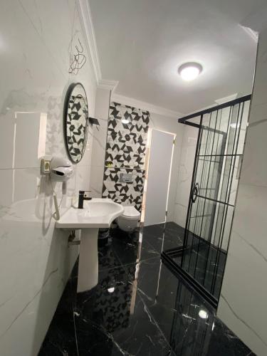a bathroom with a sink and a toilet and a mirror at Pembe Köşk Old City Center in Istanbul
