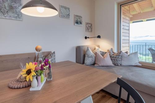 a dining room with a wooden table with flowers on it at Bio- und Vitalbauernhof Bacherhof in Millstatt