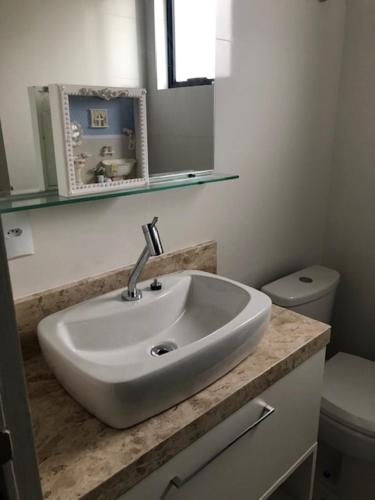 a bathroom with a sink and a toilet at Residencial ISL - Praia da Pinheira SC in Palhoça