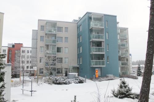 an apartment building in the snow in a city at Leinelä Apartment in Ilola