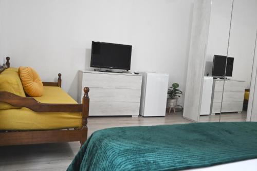 a bedroom with a bed and a tv on a dresser at Appia Antica Guest House in Rome