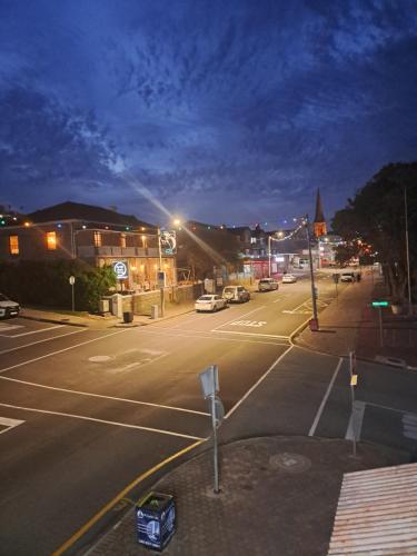 an empty street at night with cars parked at Green Door Guesthouse in Mossel Bay