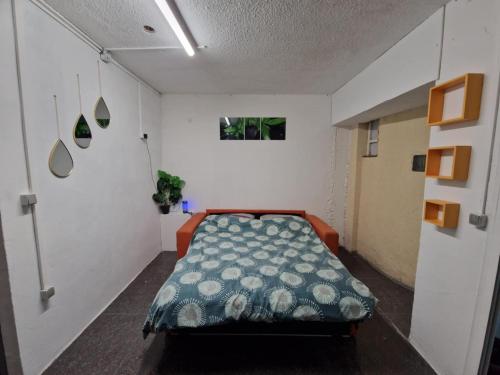 a bedroom with a bed in the middle of a room at romarin 3 in Saint-Denis