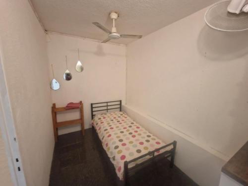 a small bedroom with a bed and a ceiling at romarin 3 in Saint-Denis