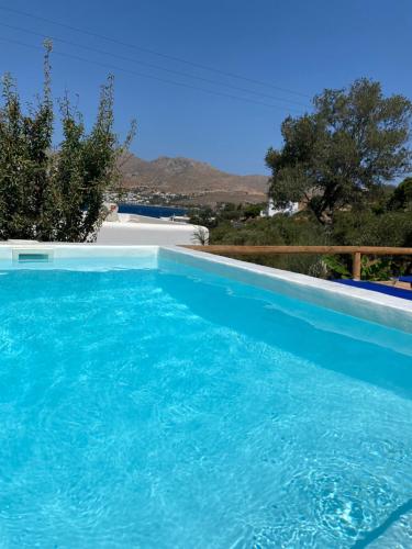 a swimming pool with blue water in a house at The Velanidies - Οι Βελανιδιές in Agia Marina