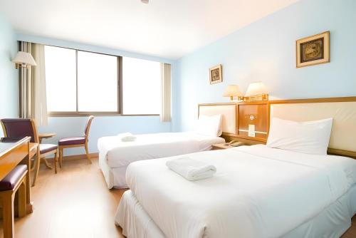 Ένα ή περισσότερα κρεβάτια σε δωμάτιο στο X Wish Inn BTS Chidlom - วิช อินน์ บีทีเอส ชิดลม