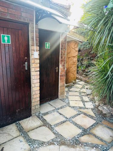 a pair of wooden doors in a house at Caribe Accommodation and Conferences in Pietermaritzburg