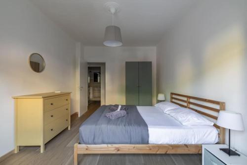 a bedroom with a large bed and a dresser and a lamp at i-HOMES Family Comfort Padova in Padova