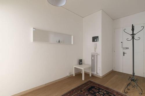 a living room with white walls and a rug at i-HOMES Family Comfort Padova in Padova