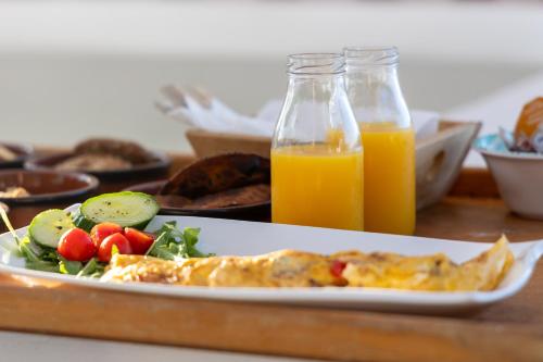 a plate of food and a bottle of orange juice at Summer Residence in Provatas
