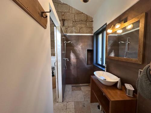 a bathroom with a sink and a mirror at Maison cantonnière in Sartène