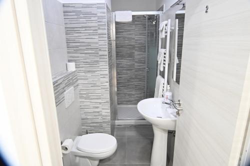 a small bathroom with a toilet and a sink at Appia Antica Guest House in Rome