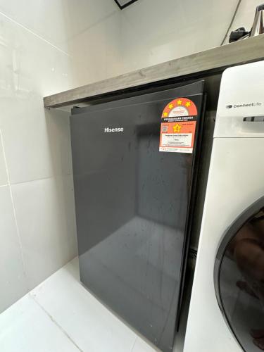 a washing machine with a sign on the door at Stylish Cozy Landed Jelutong 3Room2bath4park 10pax in Jelutong