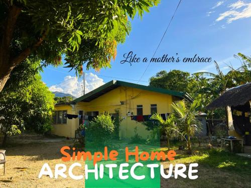 a small yellow house with the words smile home architecture at Residencia del Mundo - Hotel in Puerto Galera