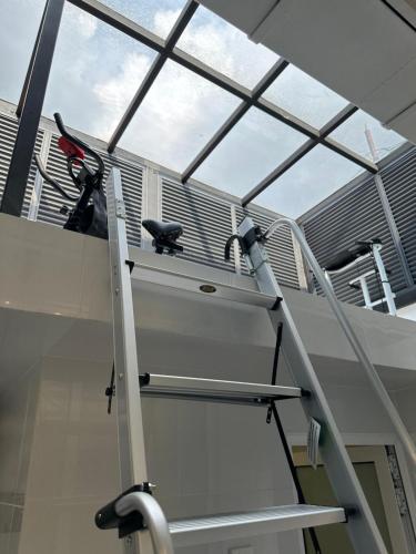 a staircase in a room with a window at Stylish Cozy Landed Jelutong 3Room2bath4park 10pax in Jelutong
