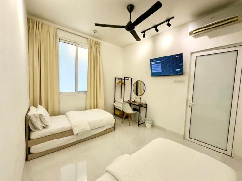 a white bedroom with a bed and a window at Stylish Cozy Landed Jelutong 3Room2bath4park 10pax in Jelutong