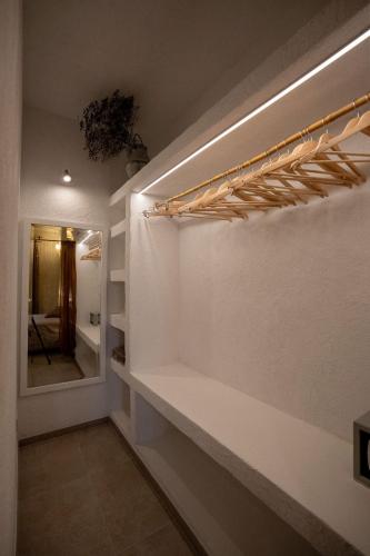 a room with a wall with a mirror and a shelf at Fontarcella, Heart & Roots in Petrignano sul Lago