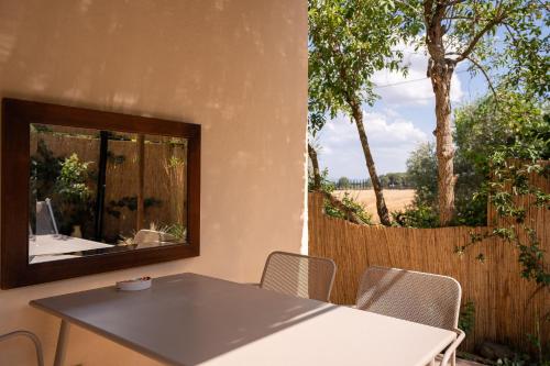 a table and chairs in a room with a mirror at Fontarcella, Heart & Roots in Petrignano sul Lago