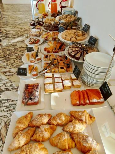 a buffet of pastries and desserts on a table at Hotel Metropol in Pesaro