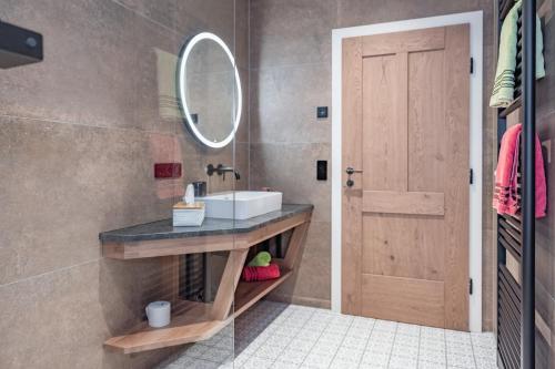 a bathroom with a sink and a mirror at Bio- und Vitalbauernhof Bacherhof in Millstatt