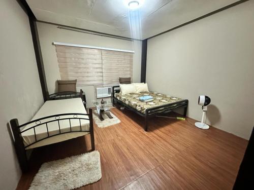 a room with two bunk beds and a table at CAVR Building in Tarlac