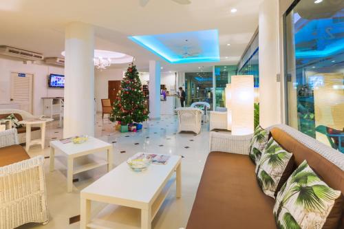 a christmas tree in the middle of a room with tables at Zing Resort & Spa in Pattaya South