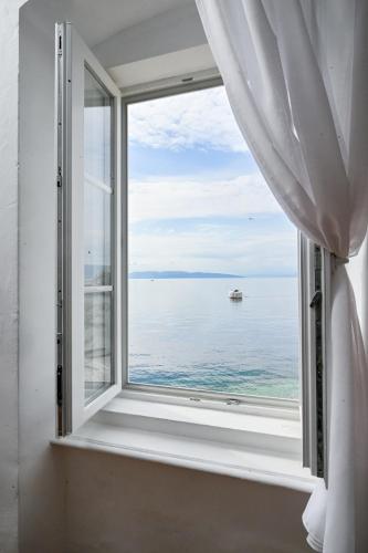 a window with a view of the ocean at Hostel Fun in Rijeka