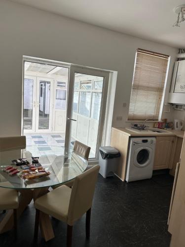 a kitchen with a glass table and chairs in a kitchen at Home and Away, close to Preston Park and Yarm High street in Stockton-on-Tees