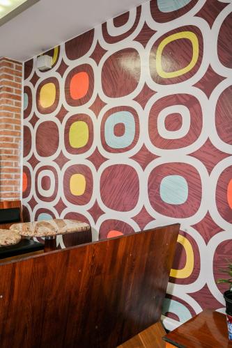 a wall with a mural of circles on it at Hostel Fun in Rijeka