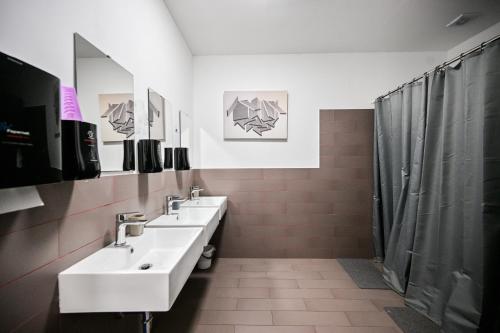 a bathroom with two sinks and a shower at Hostel Fun in Rijeka