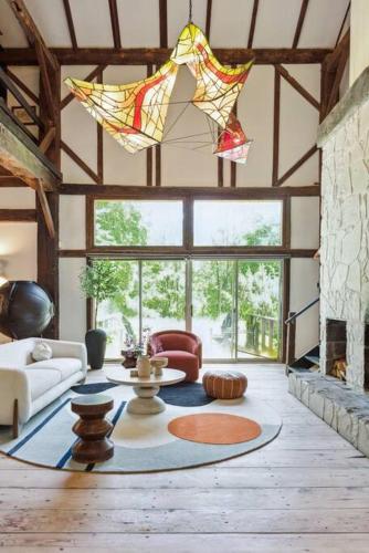 a living room with a couch and a table at Unique Fully Restored Landmark Barn in Hudson in Claverack