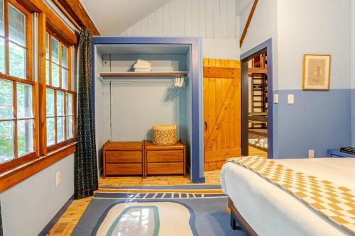 a bedroom with a bed and a dressing room at Unique Fully Restored Landmark Barn in Hudson in Claverack
