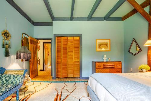 a bedroom with a bed and a wooden door at Unique Fully Restored Landmark Barn in Hudson in Claverack