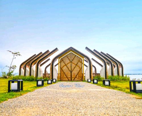 a building with a gate in the middle of a field at Mactan Newtown - New Modern Condo with Ocean View in Mactan