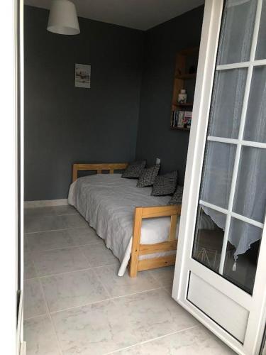 a bedroom with a bed and a large mirror at Chez Sophie et Bernard in Saverdun