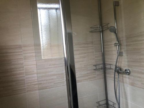 a shower in a bathroom with a glass door at Chez Sophie et Bernard in Saverdun