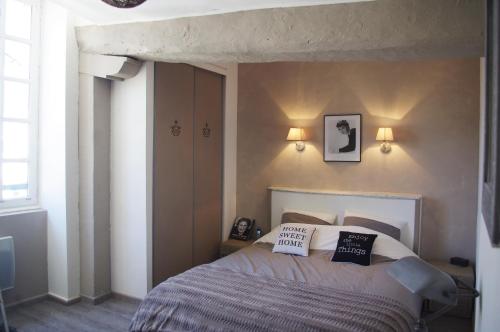a bedroom with a bed with two pillows on it at Gite Du Passant Rennais in Rennes