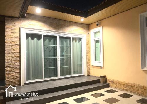 a screened in porch with a sliding glass door at บ้านพักชายโขง นครพนม b2 in Nakhon Phanom