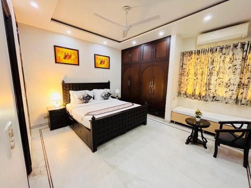 a bedroom with a bed and a table and a window at South Inn - Green Park South Delhi in New Delhi