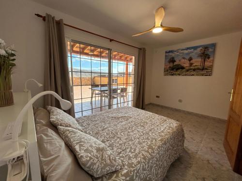 a bedroom with a bed and a view of the ocean at Casa Tortuga in Tarajalejo