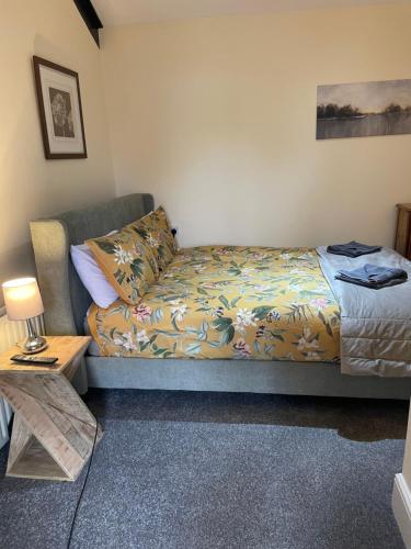 a bed and a couch in a room at The Coach House at The Bull Inn in Milton Keynes