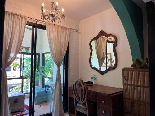 a room with a mirror and a dresser and a window at Auntie & Niece PHUKET in Ban Sam Kong