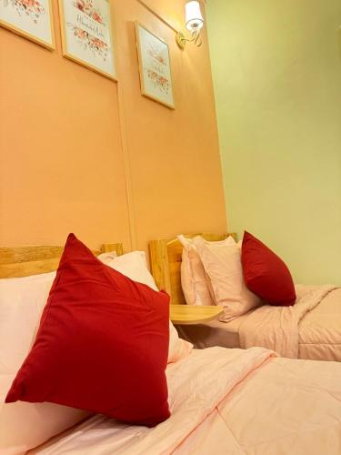 a hotel room with two beds with red pillows at Seri Idaman Room and Studio - MusIim Only in Kampong Gaung