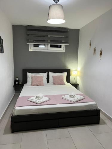 a bedroom with a bed with two towels on it at MY HOME Trikala in Tríkala