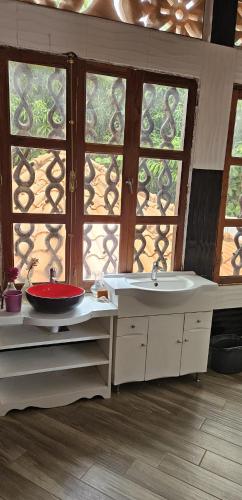 a bathroom with two sinks and a window at Belle villa in Saly Niakh-Niakhal