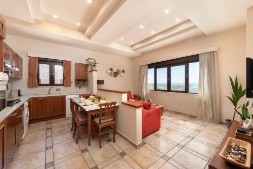 a kitchen and living room with a table and chairs at Blue Vision Luxury House in Pefki Rhodes
